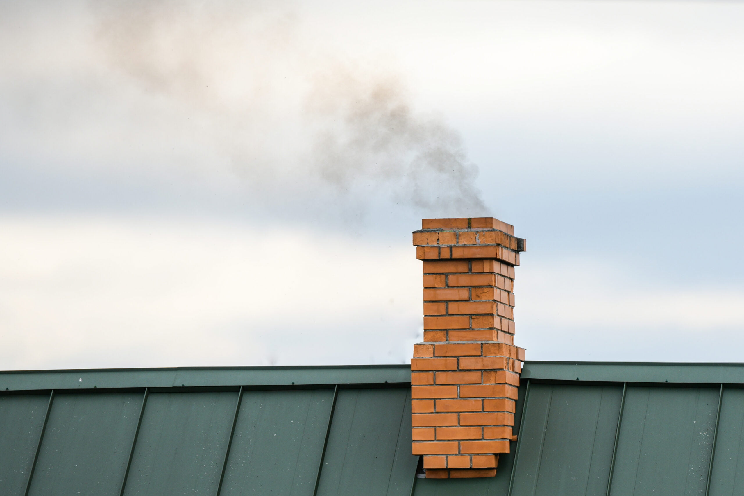 smoke-from-chimney-heating-smoke-billowing-coming-out-house-fire-prevention-chimney-against-blue-sky