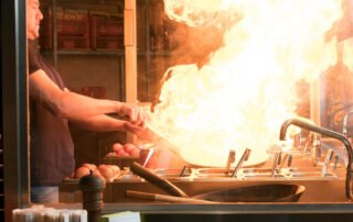 chef at restaurant with fire on stove learning about restaurant fire prevention