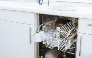 loaded dishwasher in home with dirty dishes preventing leaky dishwashers and water damage